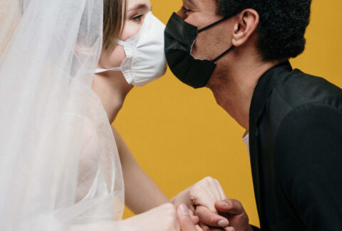 man-in-black-suit-jacket-holding-woman-in-white-wedding-3951880